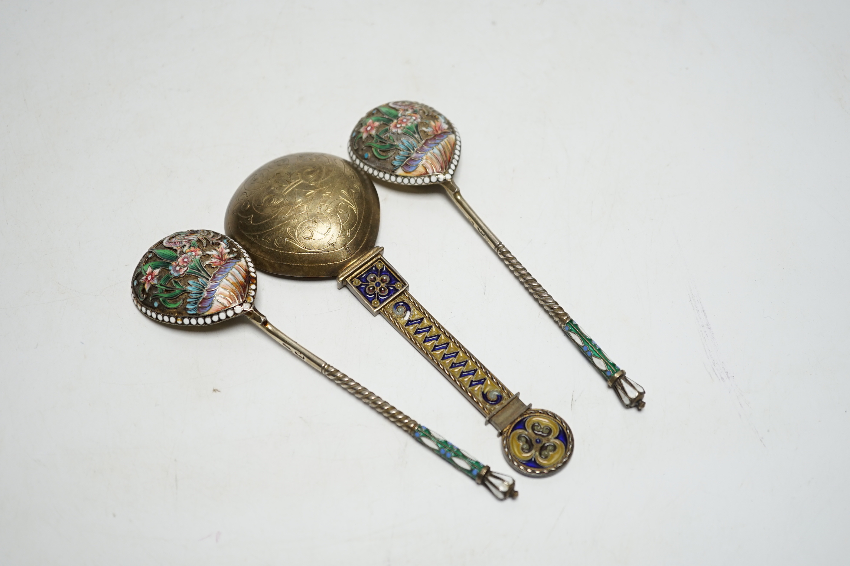 A Norwegian gilt sterling and plique a jour enamelled spoon, 16.2cm (a.f.), together with a pair of late 19th/early 20th century Russian 84 gilt zolotnik and cloisonné enamel spoons.